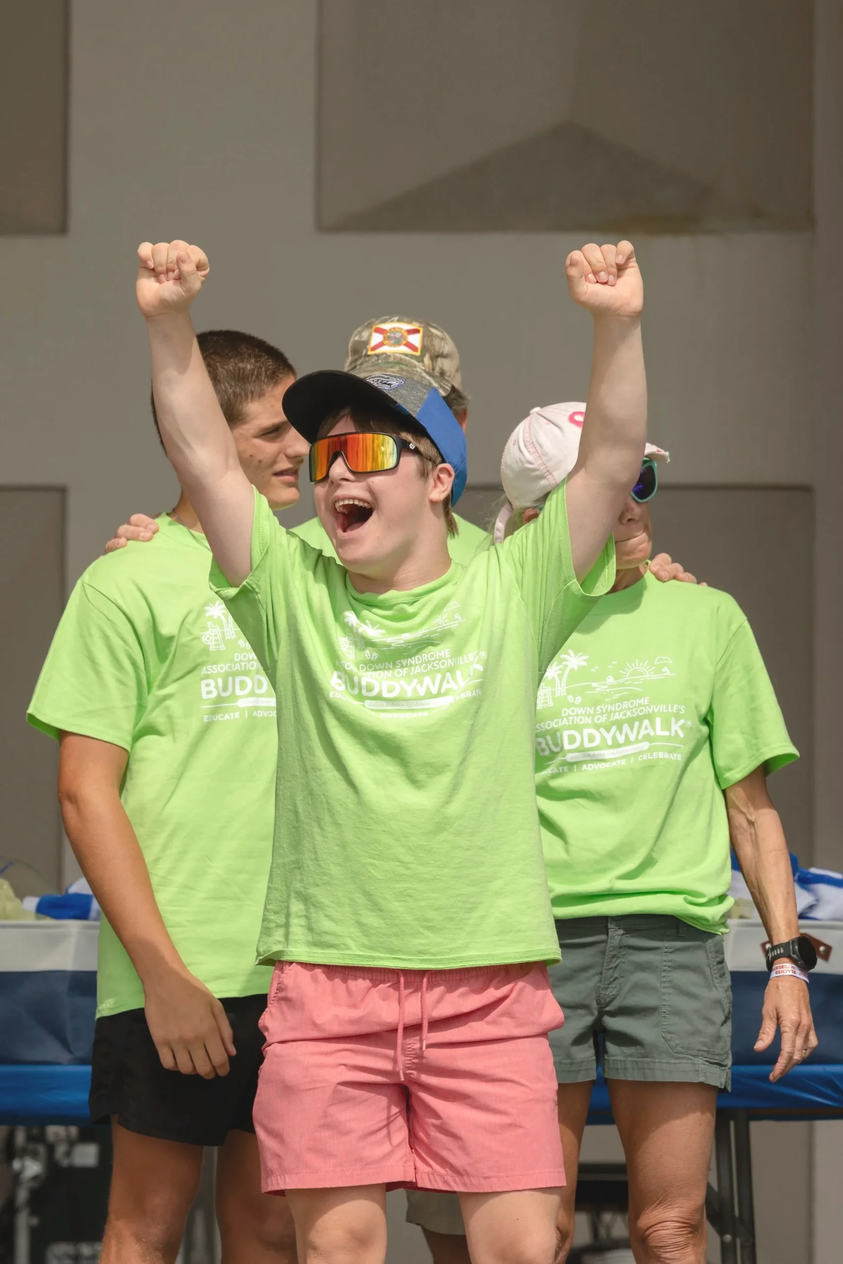 kid with arms in air celebrating