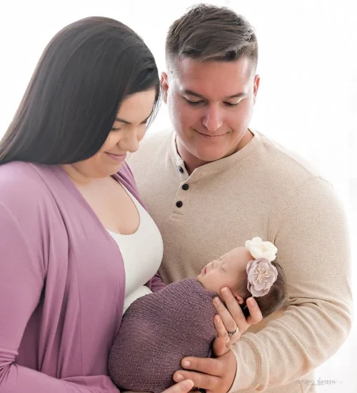 new parents holding baby
